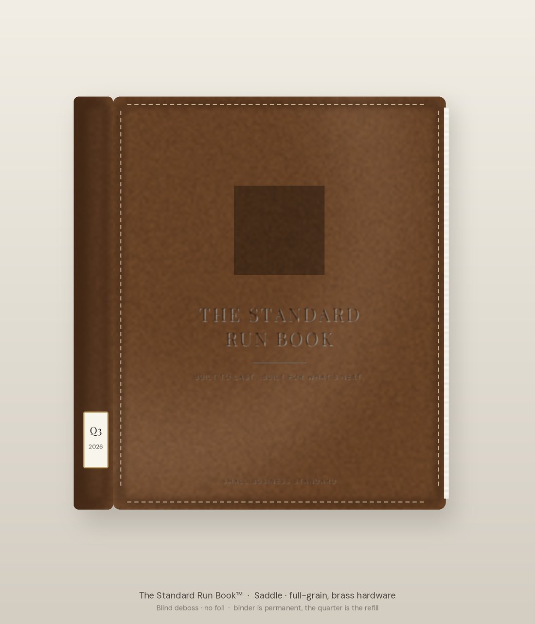 The Standard Run Book in a full-grain leather binder with a blind-debossed crest and a brass quarter card on the spine.